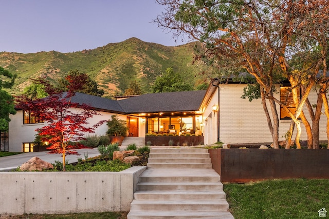 4279 S Lares Cir, Salt Lake City, UT 84124 - view of front of home with brick siding, a mountain view, and stairway