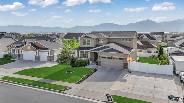 9559 S Lea Heather Way, West Jordan, UT 84081 - view of front facade featuring stone siding, a residential view, a mountain view, concrete driveway, and an attached garage