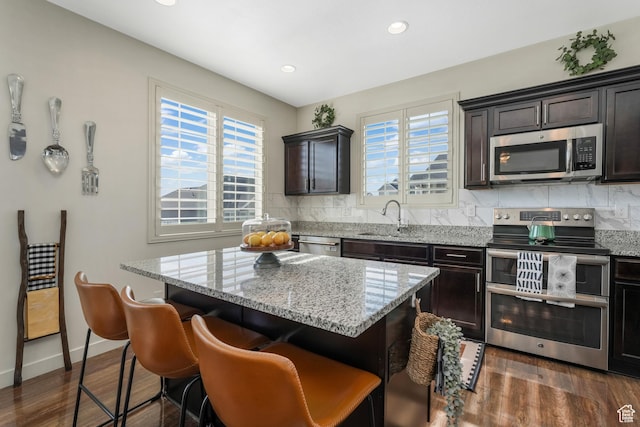 9559 S Lea Heather Way, West Jordan, UT 84081 - kitchen with stainless steel appliances, a sink, healthy amount of natural light, dark wood-type flooring, and recessed lighting