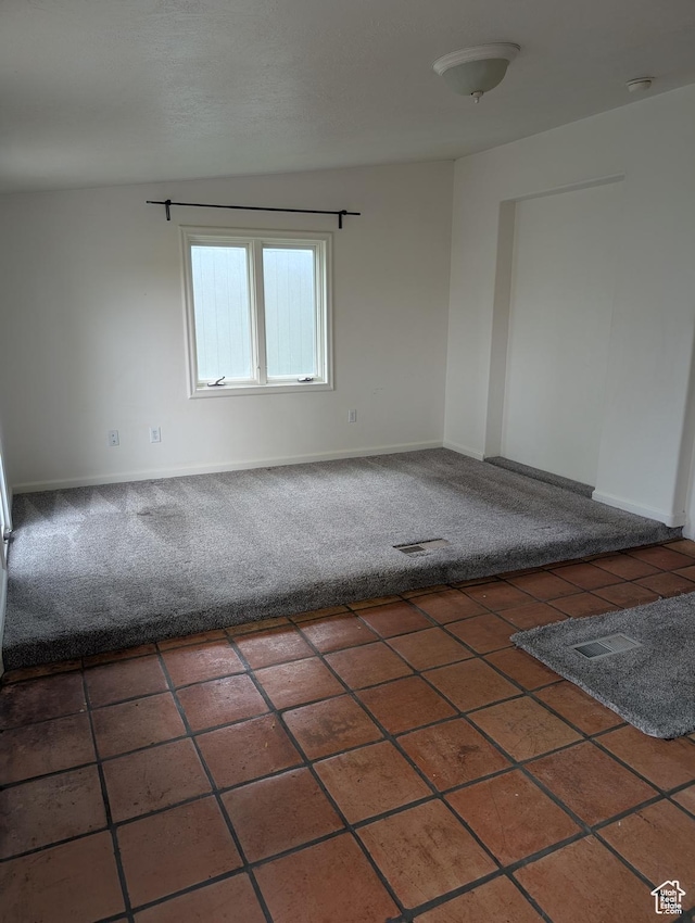 unfurnished room featuring carpet flooring and baseboards