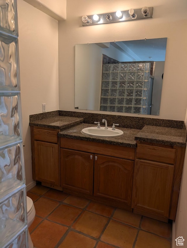 bathroom featuring vanity, tile patterned floors, and toilet