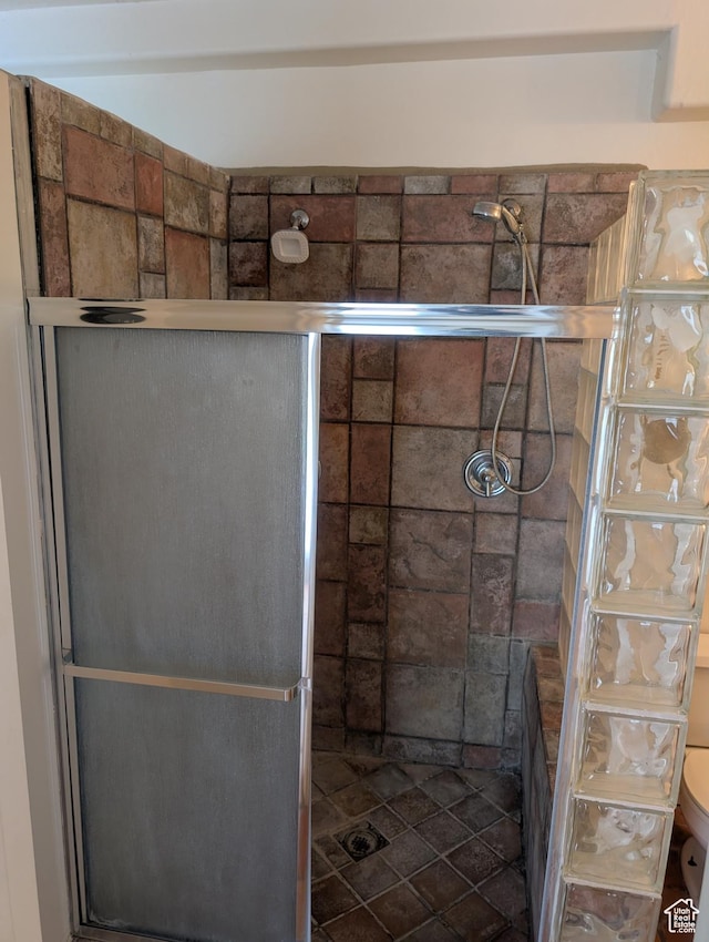 full bath with a shower stall and toilet
