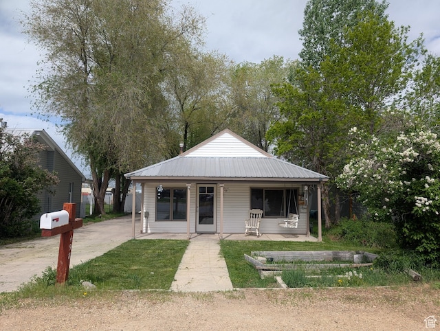 bungalow featuring metal roof