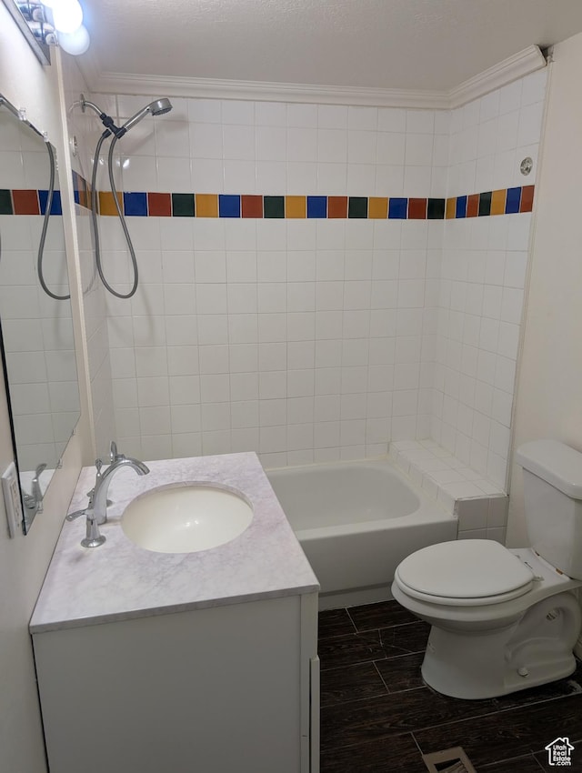 bathroom with toilet, vanity, crown molding, shower / bathtub combination, and wood finished floors
