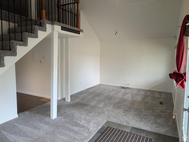 staircase featuring carpet floors, vaulted ceiling, and baseboards