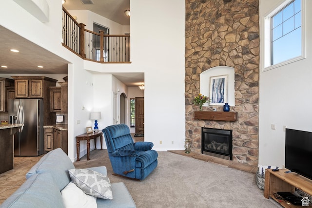 2706 W Falcon Ridge Way, Lehi, UT 84043 - living area with a towering ceiling, a stone fireplace, light colored carpet, and recessed lighting