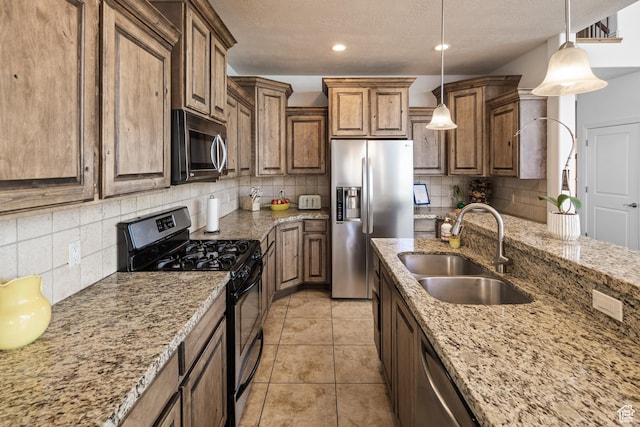 2706 W Falcon Ridge Way, Lehi, UT 84043 - kitchen featuring appliances with stainless steel finishes, a sink, decorative backsplash, light stone countertops, and a textured ceiling