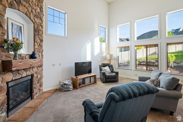 2706 W Falcon Ridge Way, Lehi, UT 84043 - carpeted living area with a towering ceiling, a stone fireplace, and baseboards