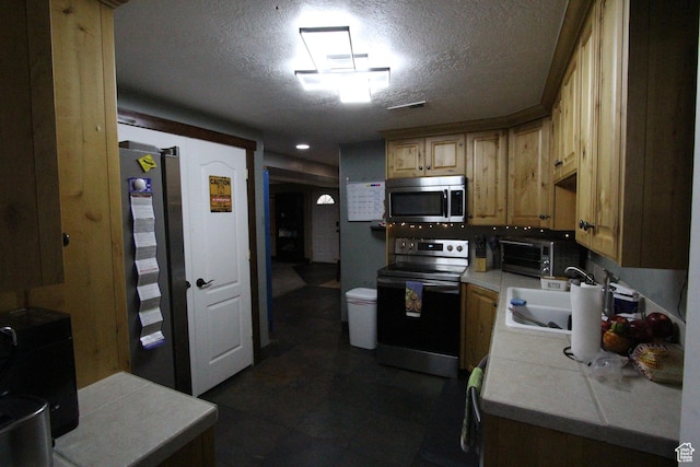 463 E 200 N, Mapleton, UT 84664 - kitchen featuring range with electric stovetop, stainless steel microwave, tile countertops, and a textured ceiling