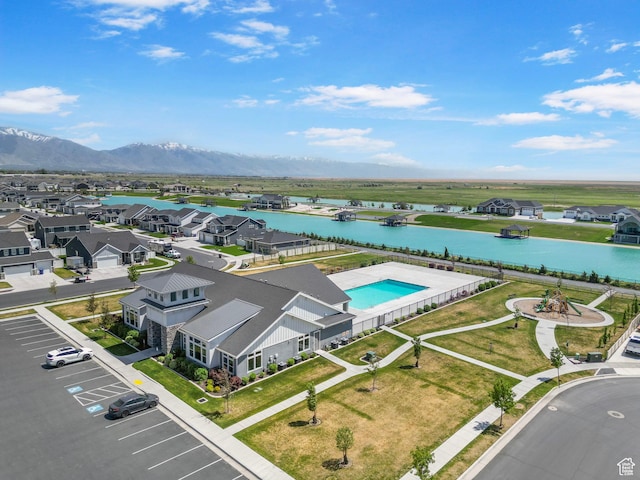 aerial view of residential area with a water and mountain view and a pool area