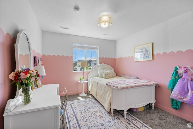 bedroom featuring carpet, baseboards, and a textured ceiling