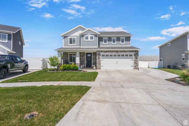 view of front of house featuring concrete driveway, a gate, stone siding, an attached garage, and board and batten siding