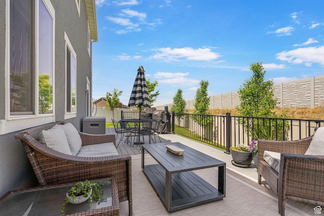 wooden terrace with outdoor dining area and outdoor lounge area