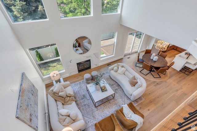 1309 W 1870 N, Provo, UT 84604 - living area featuring a high ceiling, wood finished floors, a premium fireplace, a chandelier, and baseboards
