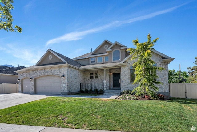 1309 W 1870 N, Provo, UT 84604 - view of front of home with covered porch, a garage, stone siding, and driveway