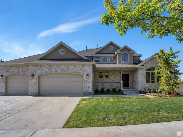 1309 W 1870 N, Provo, UT 84604 - view of front facade with a porch, an attached garage, a front yard, driveway, and stone siding