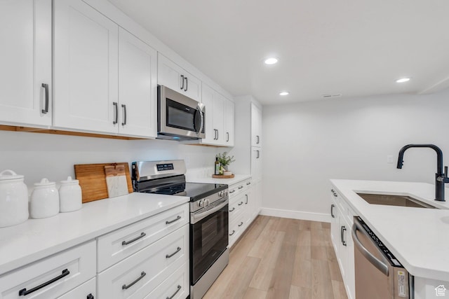 1309 W 1870 N, Provo, UT 84604 - kitchen featuring stainless steel appliances, a sink, light wood-style floors, recessed lighting, and baseboards