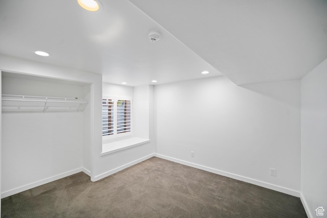 unfurnished bedroom featuring carpet, baseboards, recessed lighting, and a closet