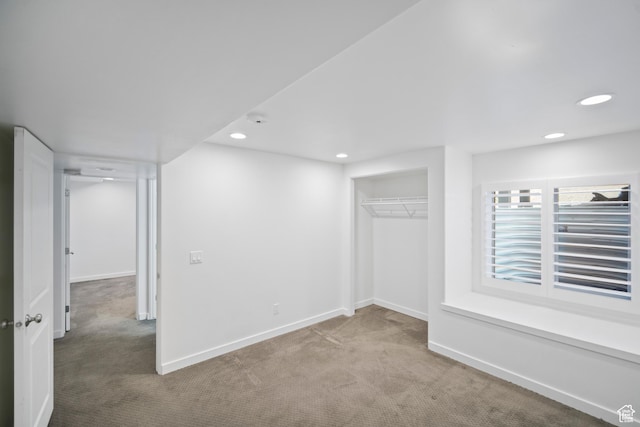 below grade area featuring carpet flooring, recessed lighting, and baseboards
