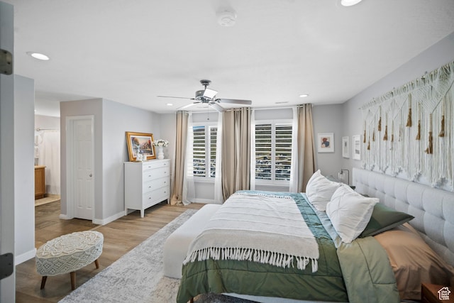 bedroom with wood finished floors, recessed lighting, ceiling fan, and baseboards