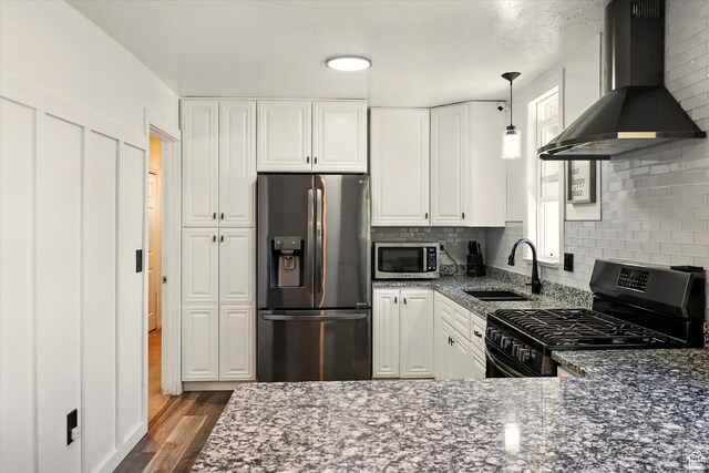 621 N 300 E, Brigham City, UT 84302 - kitchen with appliances with stainless steel finishes, extractor fan, a sink, and dark stone countertops
