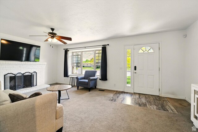 621 N 300 E, Brigham City, UT 84302 - living room with carpet flooring, a ceiling fan, baseboards, and a fireplace