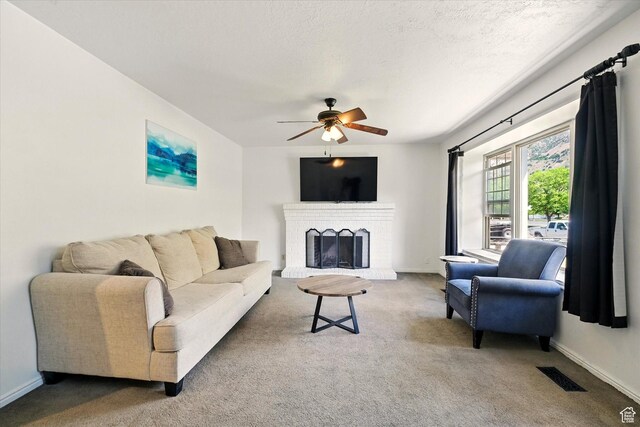 621 N 300 E, Brigham City, UT 84302 - living area featuring a ceiling fan, carpet floors, a brick fireplace, baseboards, and a textured ceiling