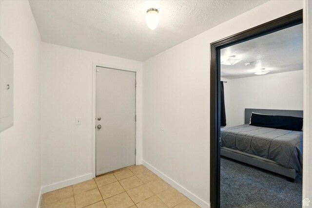 621 N 300 E, Brigham City, UT 84302 - unfurnished bedroom with baseboards, a textured ceiling, and light tile patterned flooring