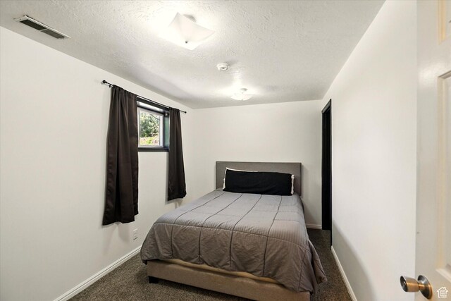 621 N 300 E, Brigham City, UT 84302 - bedroom with carpet floors, a textured ceiling, and baseboards