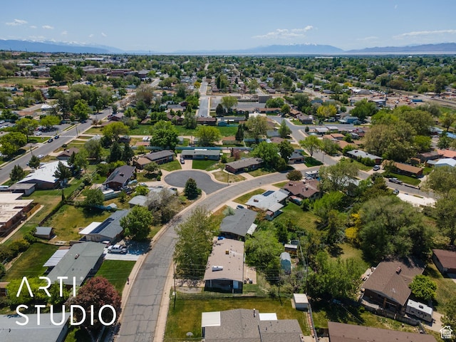 aerial view of property and surrounding area with nearby suburban area and a mountainous background