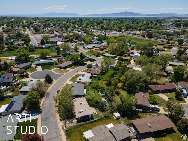 aerial view of property's location featuring nearby suburban area and a mountainous background
