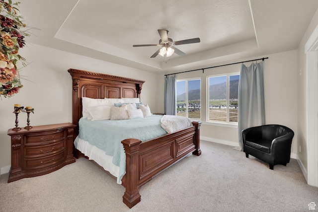 1341 S Sageberry Dr, Santaquin, UT 84655 - bedroom with a raised ceiling, light colored carpet, baseboards, a ceiling fan, and a mountain view