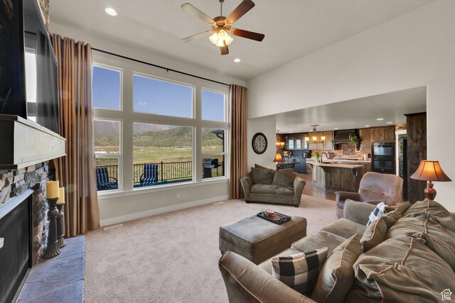 1341 S Sageberry Dr, Santaquin, UT 84655 - carpeted living area featuring a ceiling fan, a fireplace, baseboards, recessed lighting, and a sink