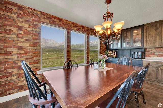 1341 S Sageberry Dr, Santaquin, UT 84655 - dining space featuring a chandelier, dark wood-style flooring, brick wall, and a mountain view