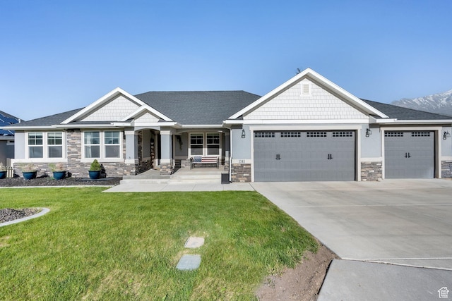 1341 S Sageberry Dr, Santaquin, UT 84655 - craftsman-style home featuring stone siding, an attached garage, a front yard, and concrete driveway