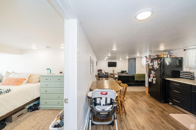 141 W 400 N, Logan, UT 84321 - bedroom with freestanding refrigerator and light wood finished floors