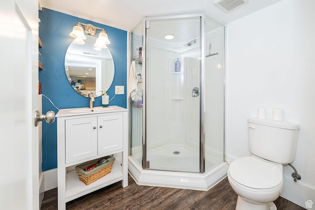 141 W 400 N, Logan, UT 84321 - bathroom featuring wood finished floors, a stall shower, toilet, and vanity