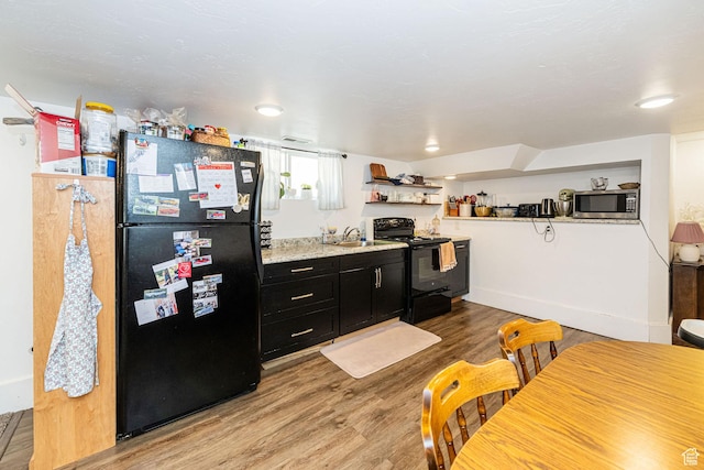 141 W 400 N, Logan, UT 84321 - kitchen featuring black appliances, dark cabinets, light wood finished floors, a sink, and open shelves