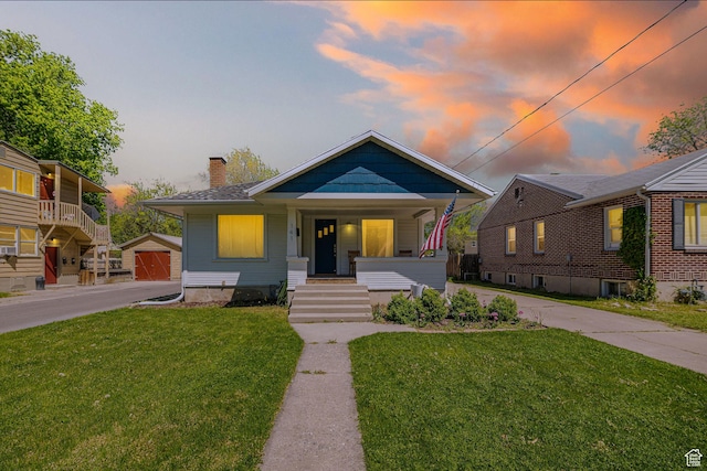 141 W 400 N, Logan, UT 84321 - bungalow-style house with a porch, a chimney, a yard, and an outdoor structure