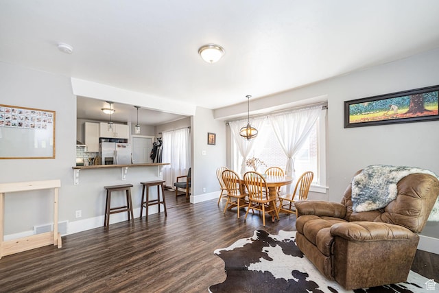 141 W 400 N, Logan, UT 84321 - living room featuring dark wood-type flooring, plenty of natural light, and baseboards