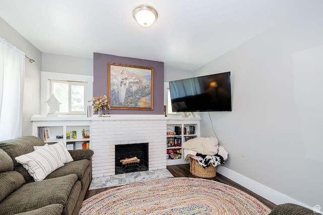 141 W 400 N, Logan, UT 84321 - living area featuring wood finished floors, a fireplace, and baseboards