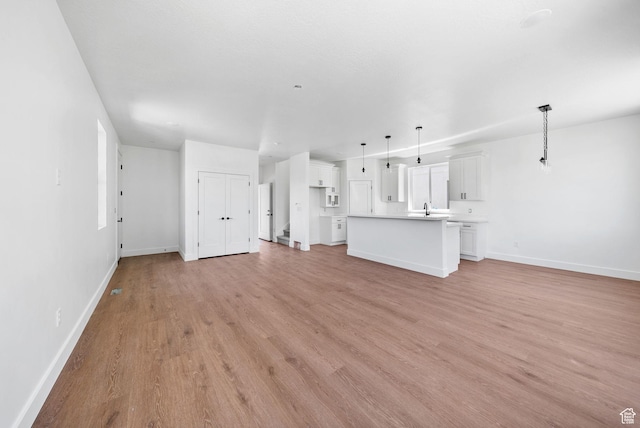295 N 1580 W Unit 101, Pleasant Grove, UT 84062 - unfurnished living room featuring a sink and light wood-style floors