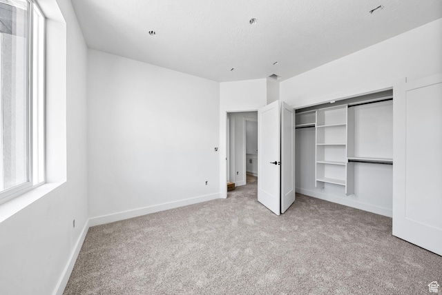 295 N 1580 W Unit 101, Pleasant Grove, UT 84062 - unfurnished bedroom with carpet flooring, a closet, and a textured ceiling