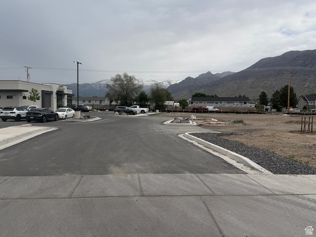 295 N 1580 W Unit 101, Pleasant Grove, UT 84062 - view of asphalt road with a mountain view and curbs