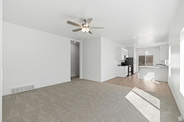 7308 Bald Eagle Way N, Eagle Mountain, UT 84005 - unfurnished living room with light colored carpet, ceiling fan, baseboards, and recessed lighting
