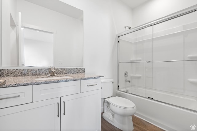 7308 Bald Eagle Way N, Eagle Mountain, UT 84005 - full bathroom featuring wood finished floors, vanity, toilet, and combined bath / shower with glass door