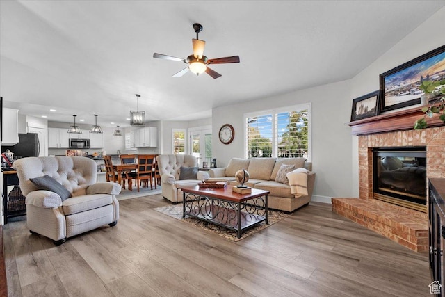 10539 S Haven View Ct W, South Jordan, UT 84095 - living room featuring a brick fireplace, light wood-style flooring, ceiling fan, and recessed lighting