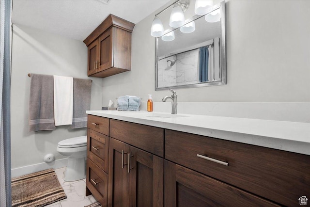 10539 S Haven View Ct W, South Jordan, UT 84095 - bathroom with marble look tiles, toilet, baseboards, vanity, and a shower