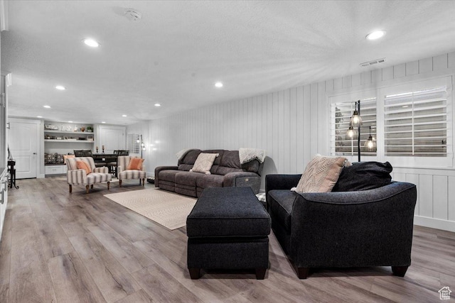 10539 S Haven View Ct W, South Jordan, UT 84095 - living area with wood finished floors, recessed lighting, and a decorative wall