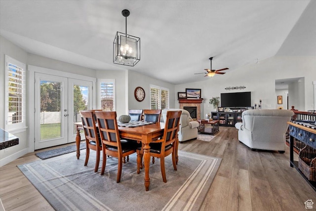 10539 S Haven View Ct W, South Jordan, UT 84095 - dining area featuring light wood finished floors, a fireplace, lofted ceiling, ceiling fan, and french doors
